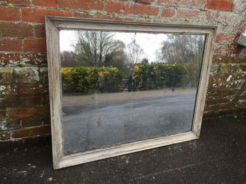 A Highly Distressed Painted Antique 19th Century French Carved Wood and Gesso Mirror.