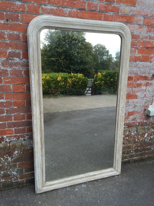 A Large Antique 19th Century French Carved Wood and Gesso Slightly Distressed Painted Arched Top Mirror.
