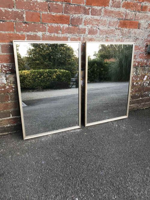 A Spectacular Pair of Thin Framed Carved Wood Original Silvered Plain Mirrors.