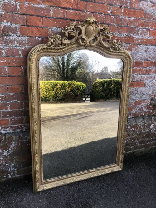 A Delightful Large Antique 19th Century French Carved Wood and Gesso Shaped Top Original Gilt Mirror.