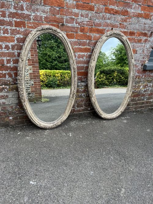 A Superb Pair of Antique French 19th Century Carved Wood Painted Oval Mirrors.