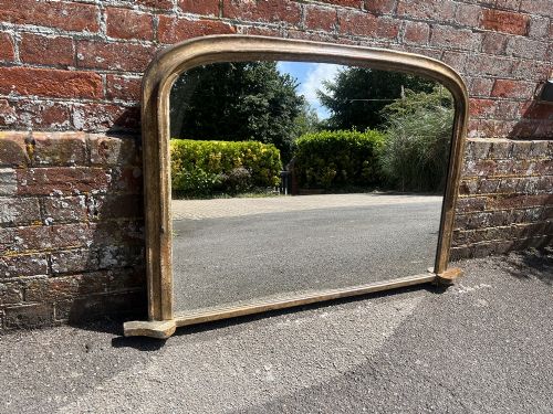 A Highly Useful Size Antique English 19th Century Arched Top Distressed Gilt Overmantle Mirror.