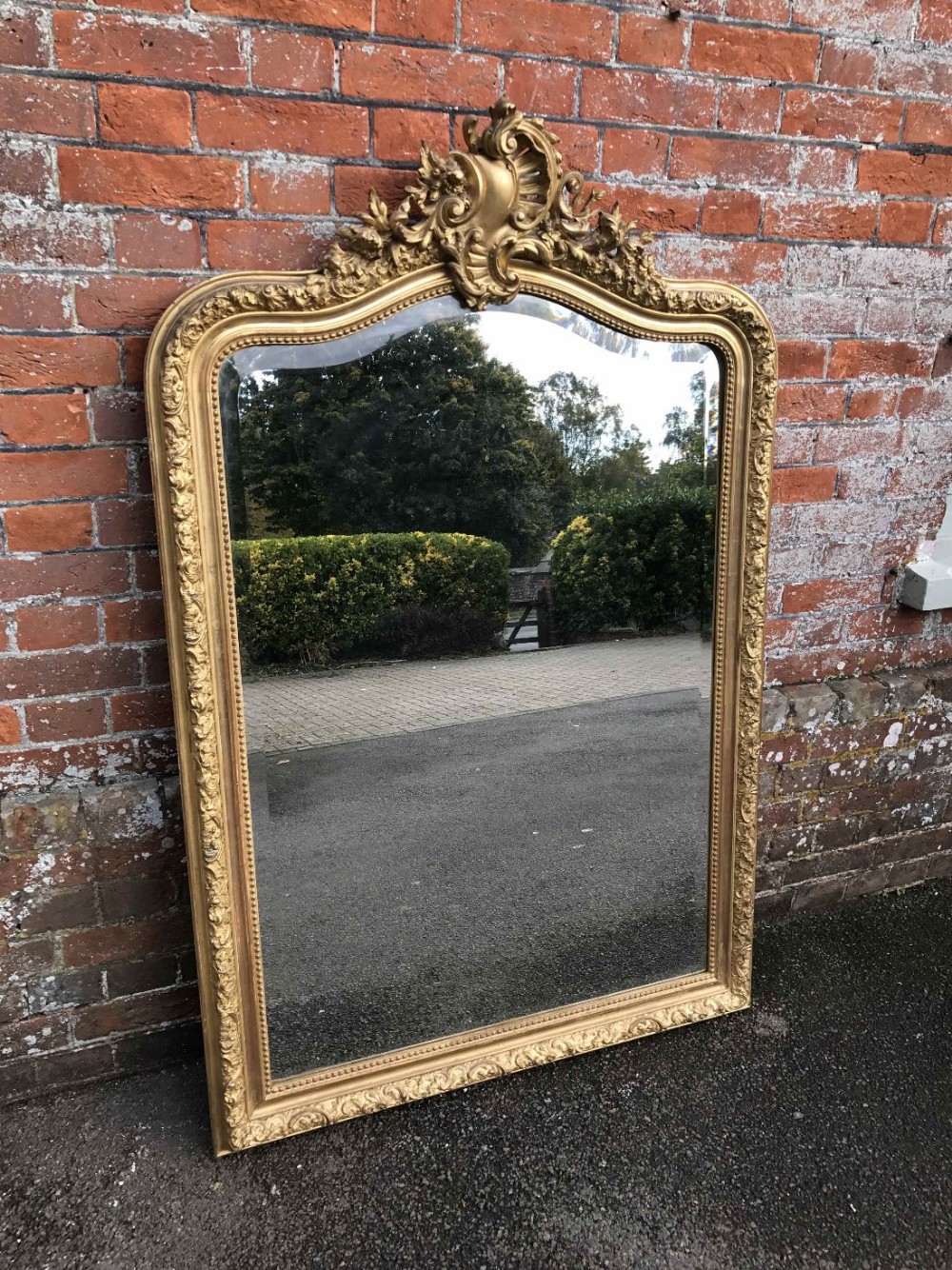 A Stunning Large Antique 19th Century French carved wood and gesso original gilt shaped top Mirror.