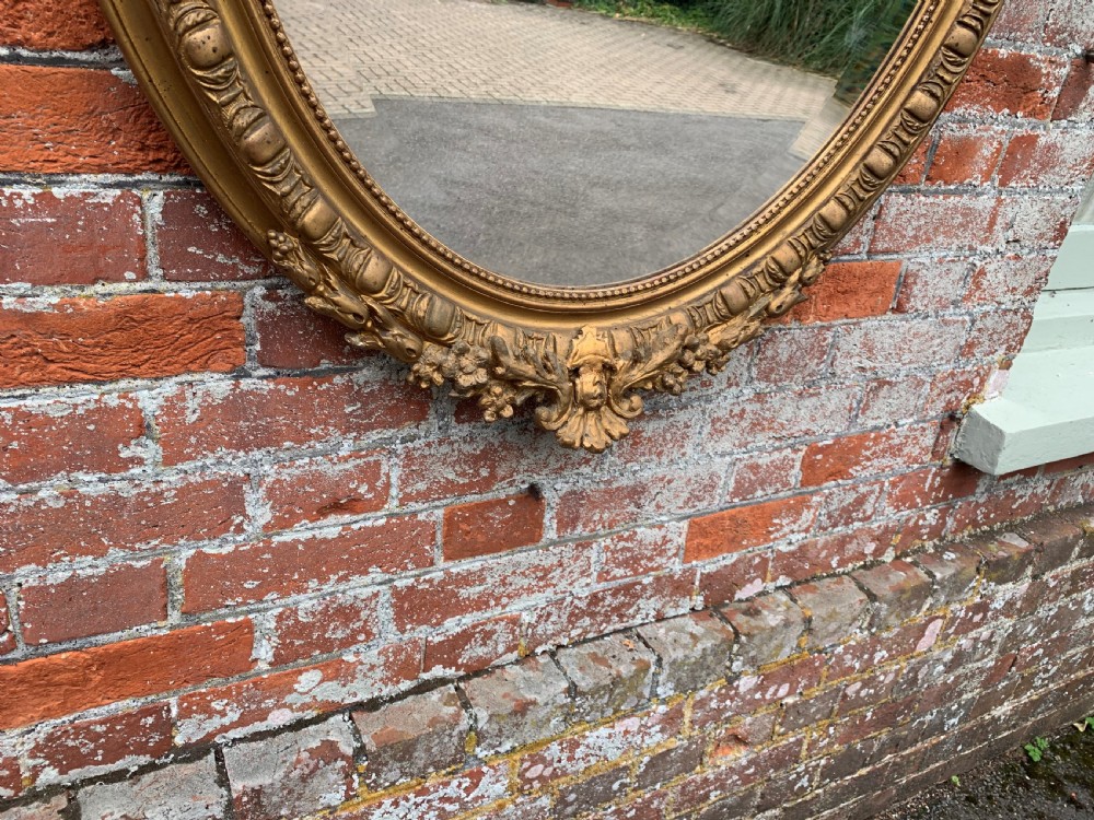 A Delightful good size Antique French 19th Century carved wood and gesso original gilt Oval Mirror. View IV
