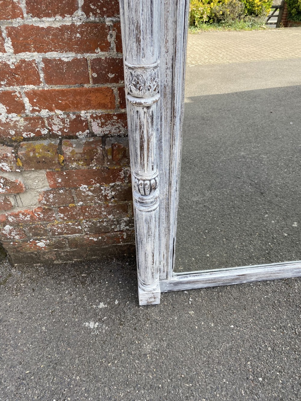 A large French nineteenth-century painted carved wood wall mirror featuring classical side columns and a detailed architectural cornice. View II