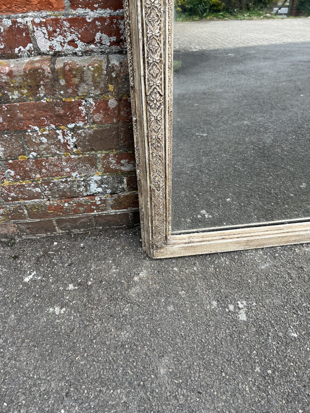 A large 19th-century arched overmantel mirror with a carved wood and gesso frame in a distressed off-white painted finish. View III