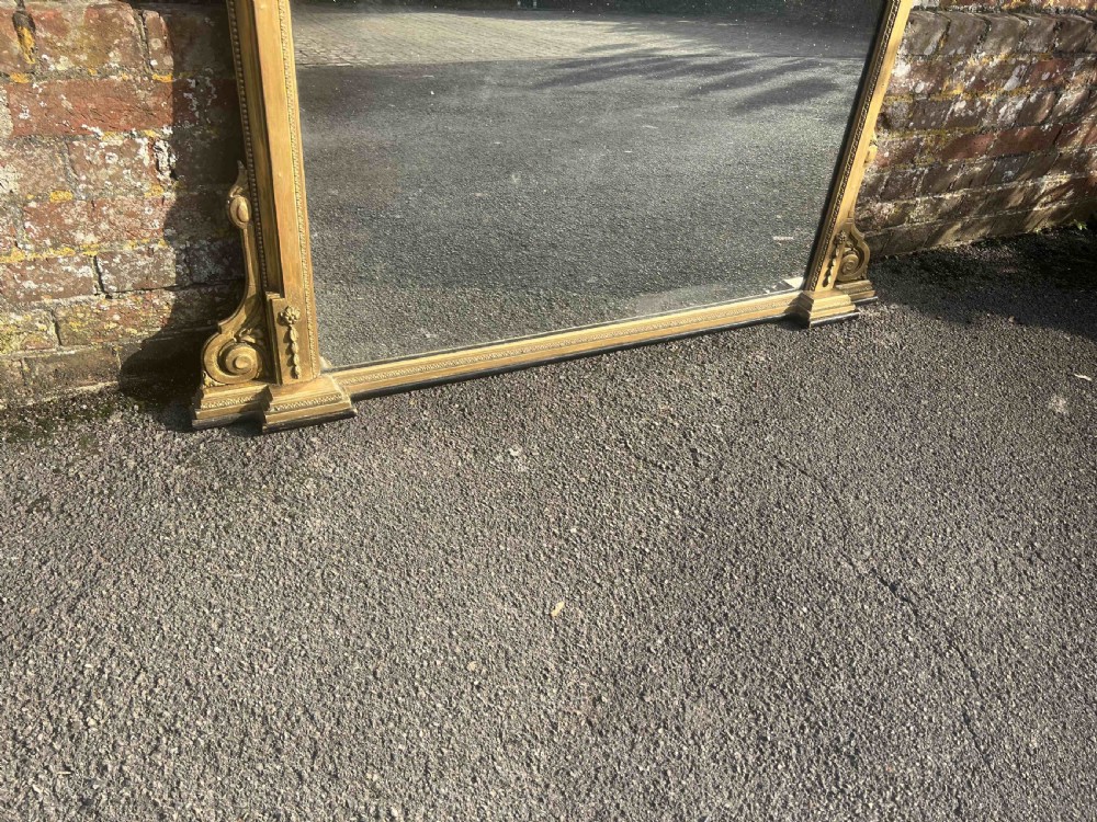 A Fabulous large Antique English 19th Century carved wood & gesso shaped top gilt Overmantle Mirror. View IV