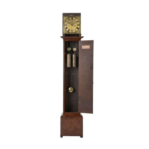 fig 4. A slender late 17th-century walnut longcase clock featuring a square brass dial, barley twist hood columns, and rich figure-grained timber.
