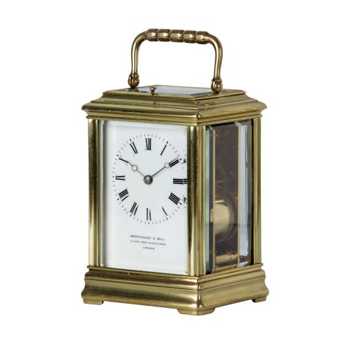 fig 1. A solid brass repeating carriage clock viewed from behind with its bevelled glass rear door open to reveal the mechanical movement and coiled gong.