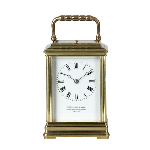 fig 2. A solid brass repeating carriage clock viewed from behind with its bevelled glass rear door open to reveal the mechanical movement and coiled gong.