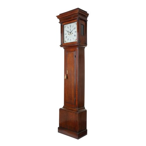 fig 1. A tall Georgian oak longcase clock featuring a square painted dial, columned hood, and hinged trunk door.