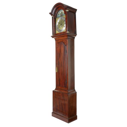 fig 1. An antique Georgian flame mahogany longcase clock featuring an arched hood with brass-capped pillars and a silvered brass dial topped with a painted rocking ship automaton.