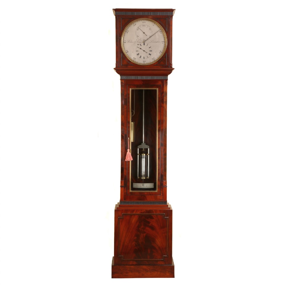 An English flame mahogany longcase regulator clock with a silvered dial signed by Pearce and Sons Leicester, featuring a glass glazed trunk displaying a mercury pendulum.