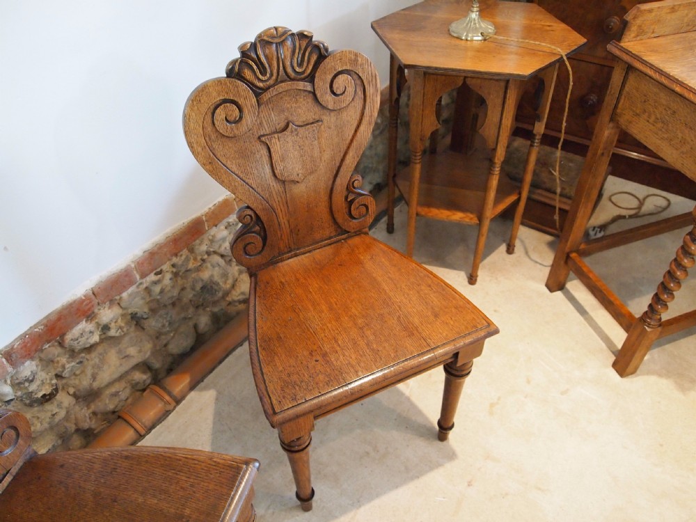 Chairs pair of William IV carved Oak hall chairs c1835 View V
