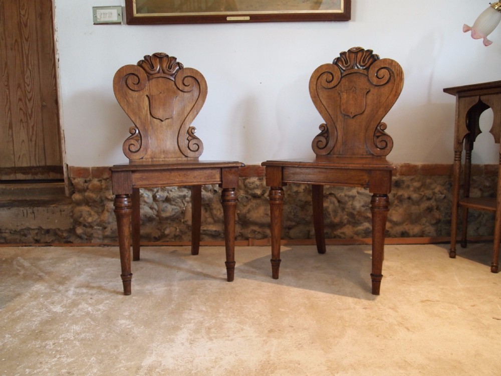 Chairs pair of William IV carved Oak hall chairs c1835 View VI