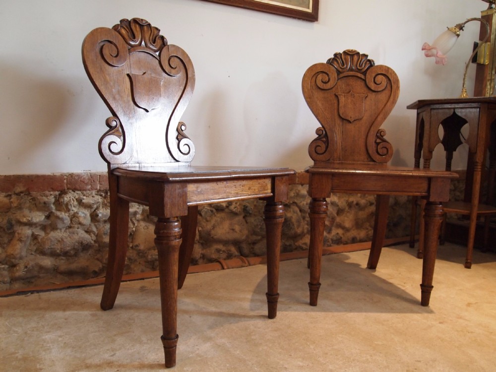 Chairs pair of William IV carved Oak hall chairs c1835 View IX