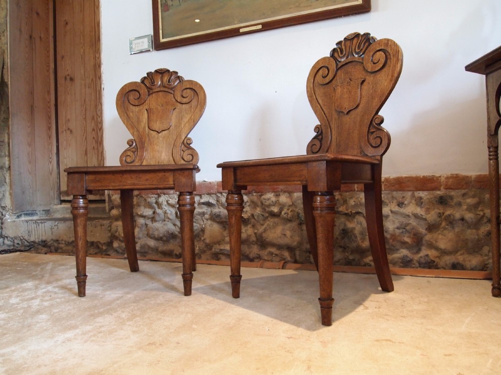 Chairs pair of William IV carved Oak hall chairs c1835 View X