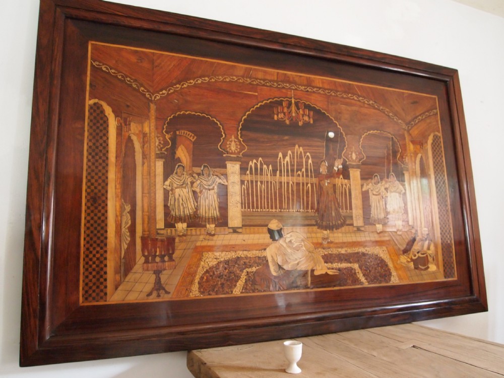 A large rectangular Indian specimen wood marquetry panel depicting a detailed court performance scene framed in dark polished wood. View II