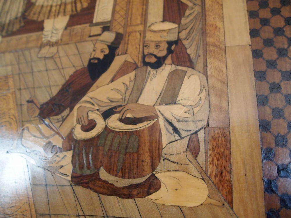 A large rectangular Indian specimen wood marquetry panel depicting a detailed court performance scene framed in dark polished wood. View V