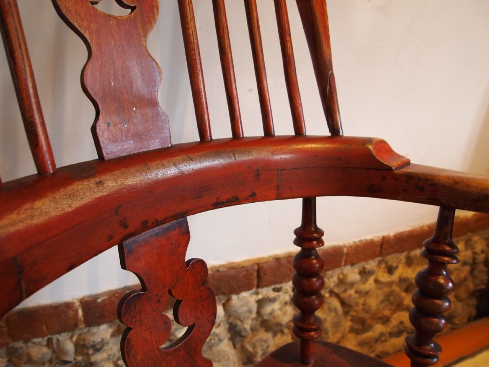 A Victorian wooden Windsor armchair with a high hoop back, central pierced splat, turned spindles, and turned legs with stretchers. View VI
