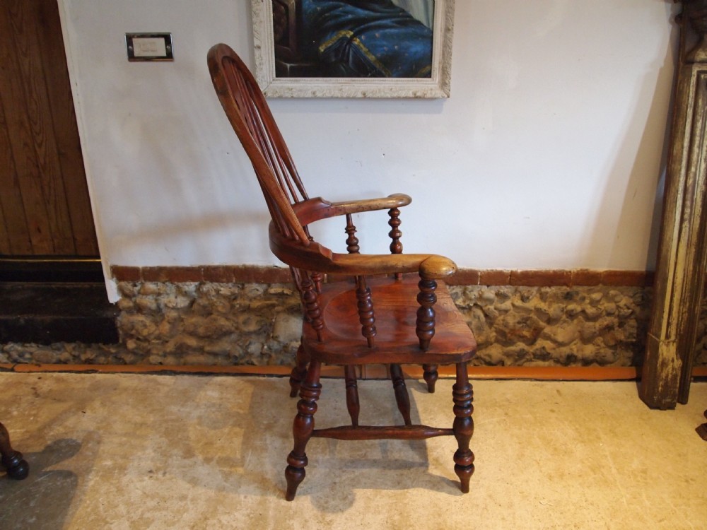 A Victorian wooden Windsor armchair with a high hoop back, central pierced splat, turned spindles, and turned legs with stretchers. View VIII