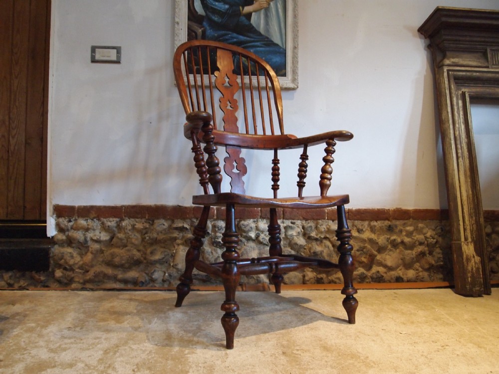 A Victorian wooden Windsor armchair with a high hoop back, central pierced splat, turned spindles, and turned legs with stretchers. View XI