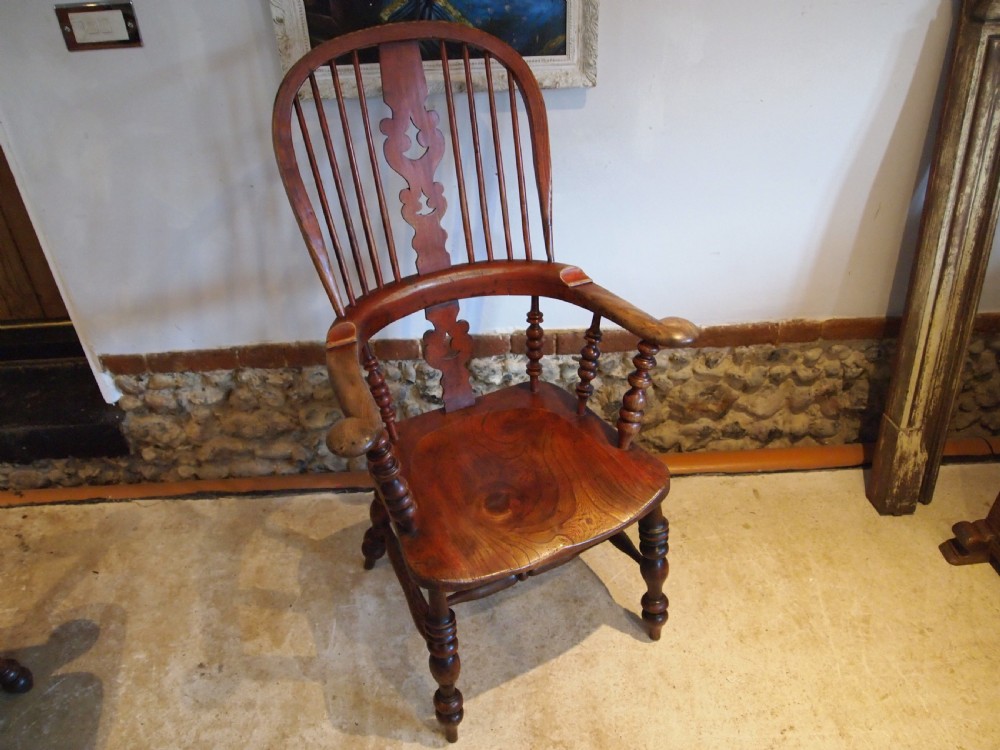 A Victorian wooden Windsor armchair with a high hoop back, central pierced splat, turned spindles, and turned legs with stretchers. View XIII