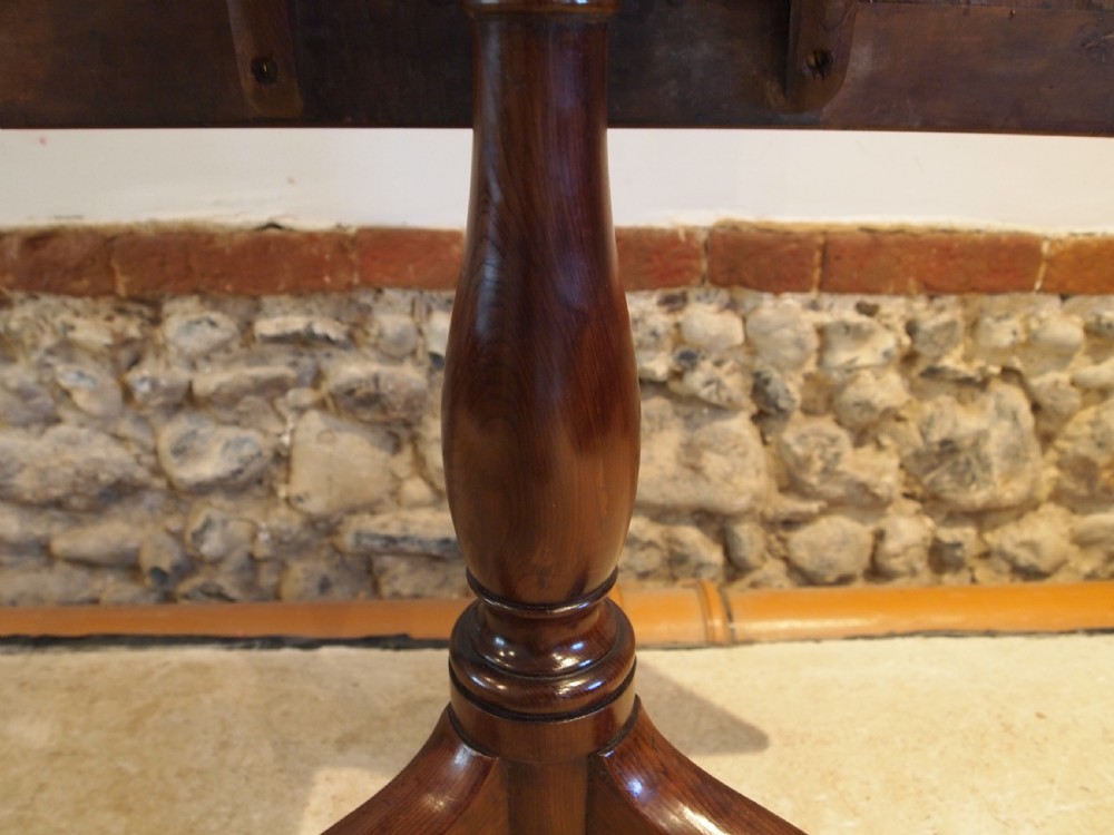 A George III yew wood tripod table featuring a rectangular top supported by a turned central column and three curved cabriole legs. View IV