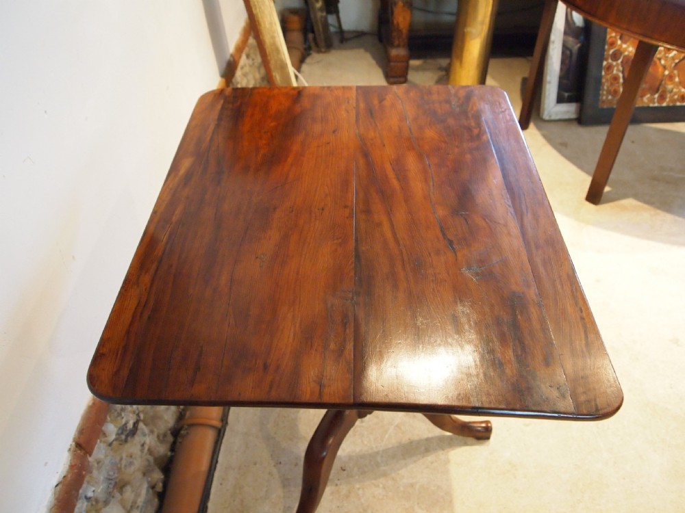 A George III yew wood tripod table featuring a rectangular top supported by a turned central column and three curved cabriole legs. View X