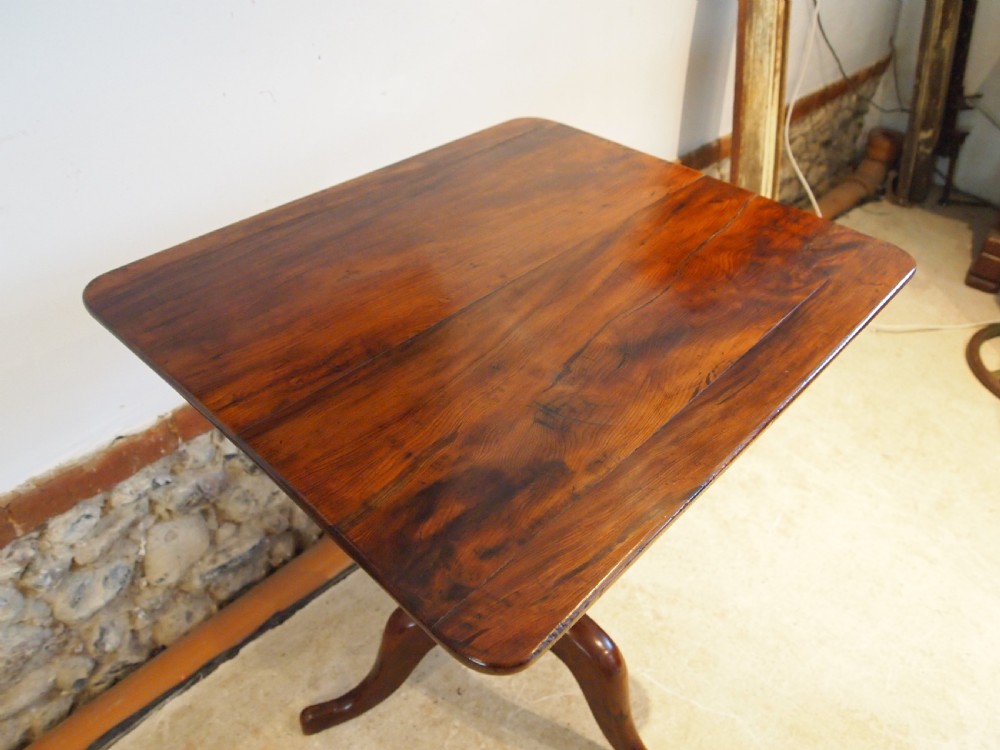 A George III yew wood tripod table featuring a rectangular top supported by a turned central column and three curved cabriole legs. View XII
