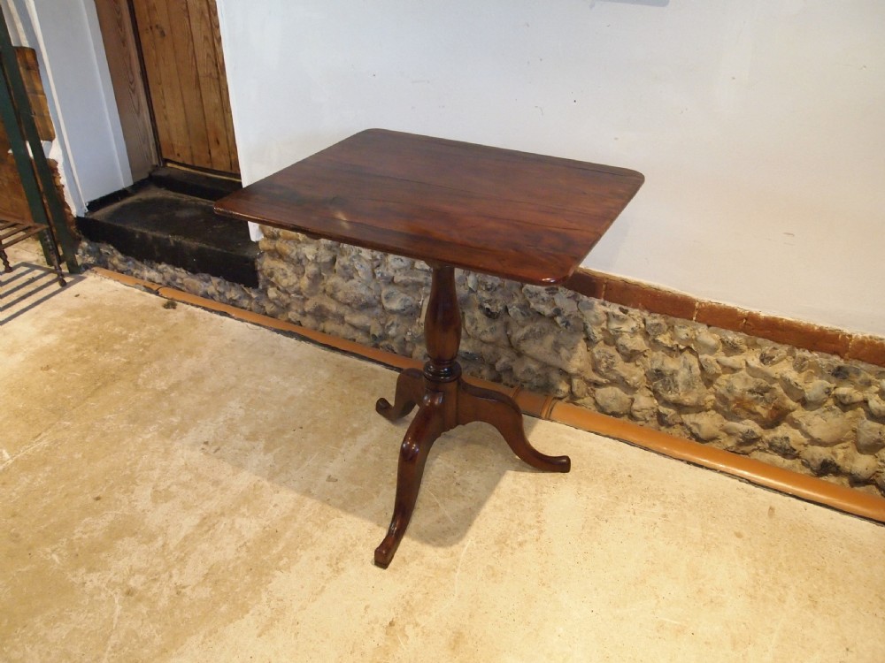 A George III yew wood tripod table featuring a rectangular top supported by a turned central column and three curved cabriole legs. View XIV