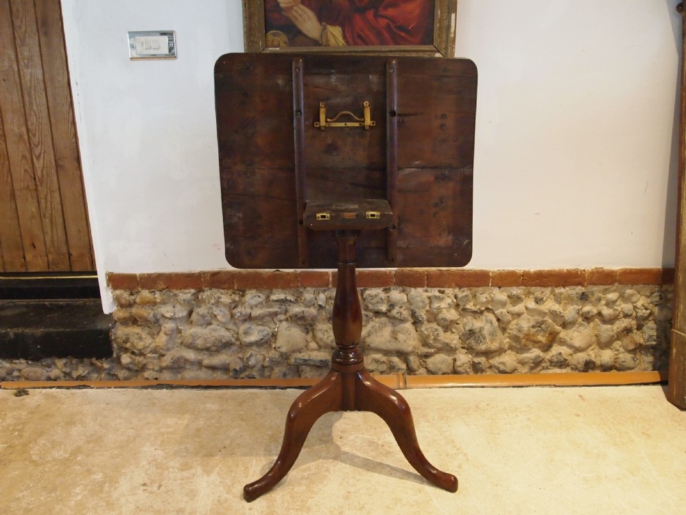 A George III yew wood tripod table featuring a rectangular top supported by a turned central column and three curved cabriole legs. View XV
