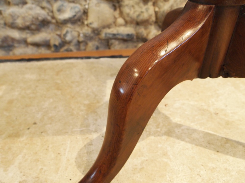 A George III yew wood tripod table featuring a rectangular top supported by a turned central column and three curved cabriole legs. View XVI