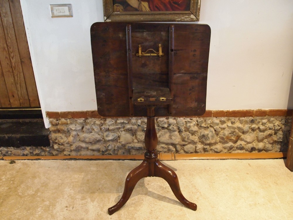 A George III yew wood tripod table featuring a rectangular top supported by a turned central column and three curved cabriole legs. View XIX