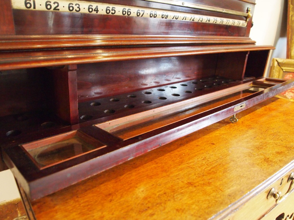 A Victorian mahogany snooker scoreboard featuring brass tracking rails, numbered rollers, a central chalkboard, and a glass-fronted lower cabinet. View V