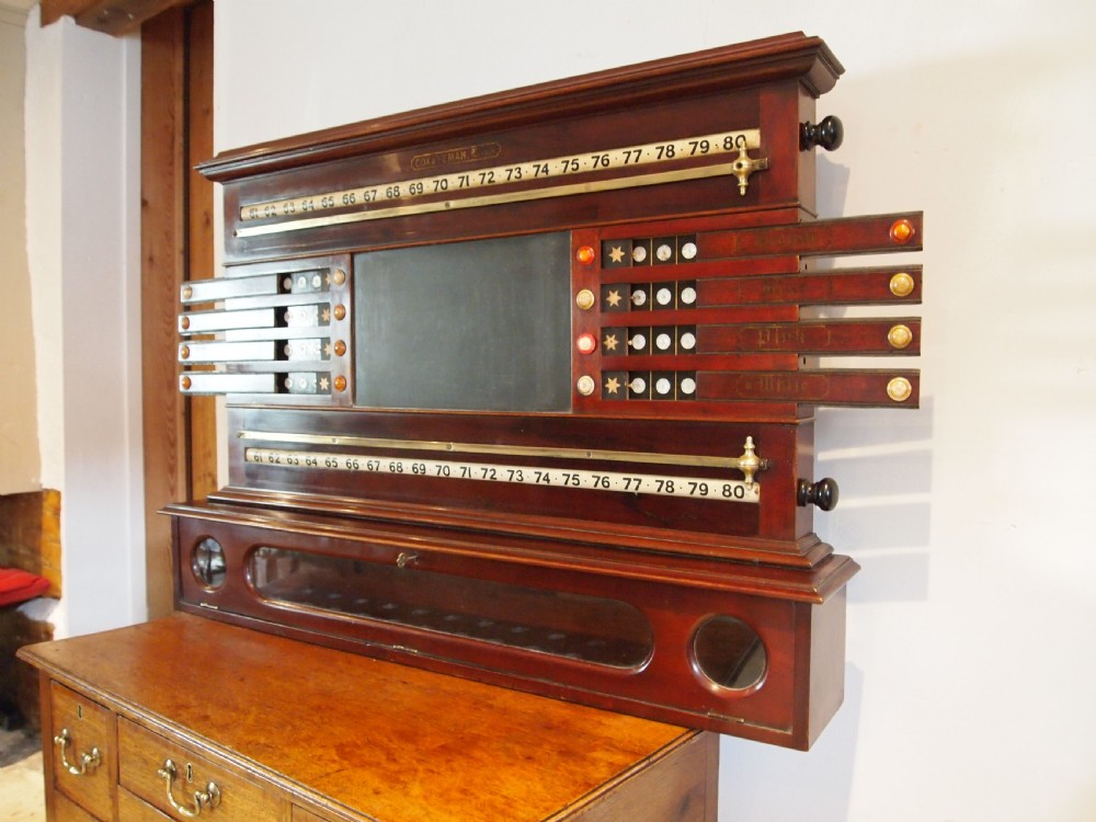 A Victorian mahogany snooker scoreboard featuring brass tracking rails, numbered rollers, a central chalkboard, and a glass-fronted lower cabinet. View XII