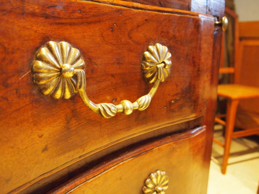 An 18th-century French walnut slant-front bureau desk featuring three wide drawers with ornamental brass handles and keyhole escutcheons. View VI
