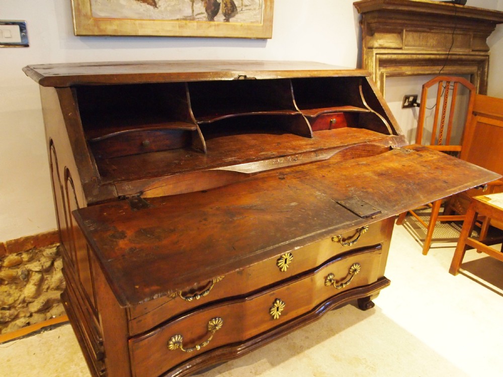 An 18th-century French walnut slant-front bureau desk featuring three wide drawers with ornamental brass handles and keyhole escutcheons. View XI