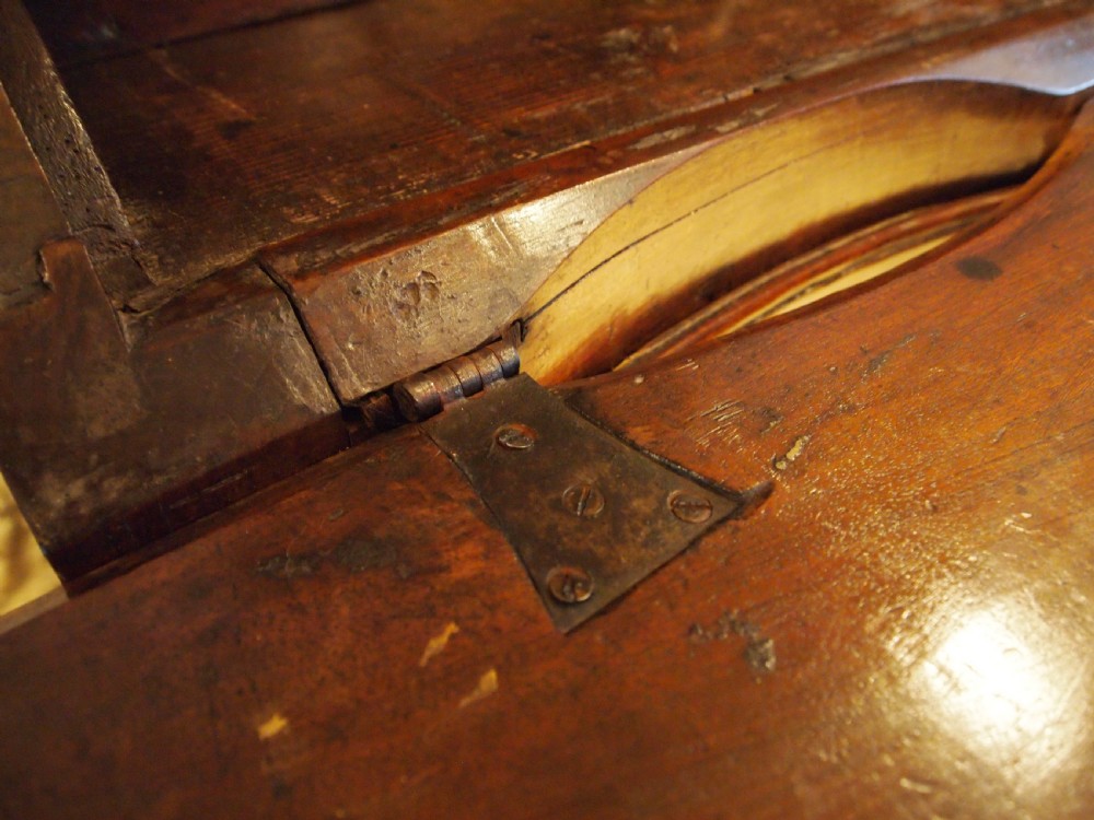 An 18th-century French walnut slant-front bureau desk featuring three wide drawers with ornamental brass handles and keyhole escutcheons. View XV