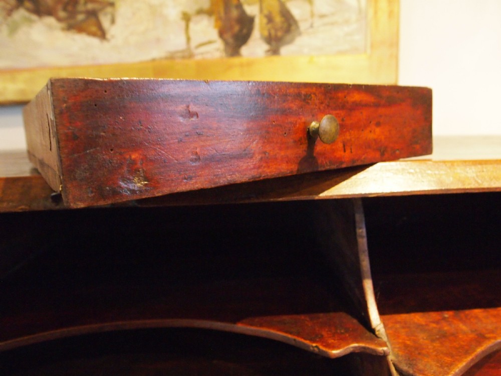 An 18th-century French walnut slant-front bureau desk featuring three wide drawers with ornamental brass handles and keyhole escutcheons. View XXI