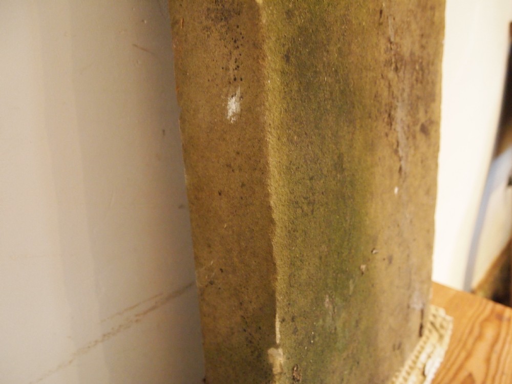 A weathered Victorian York stone headstone with an arched top, featuring carved initials and the date 1868. View II