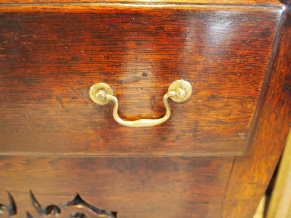 An 18th-century Welsh oak potboard dresser featuring an open plate rack, small upper drawers, a base with main drawers, shaped aprons, and turned legs. View III