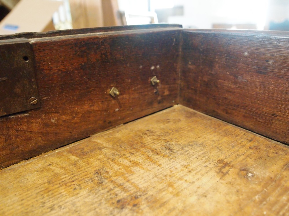 An 18th-century Welsh oak potboard dresser featuring an open plate rack, small upper drawers, a base with main drawers, shaped aprons, and turned legs. View X