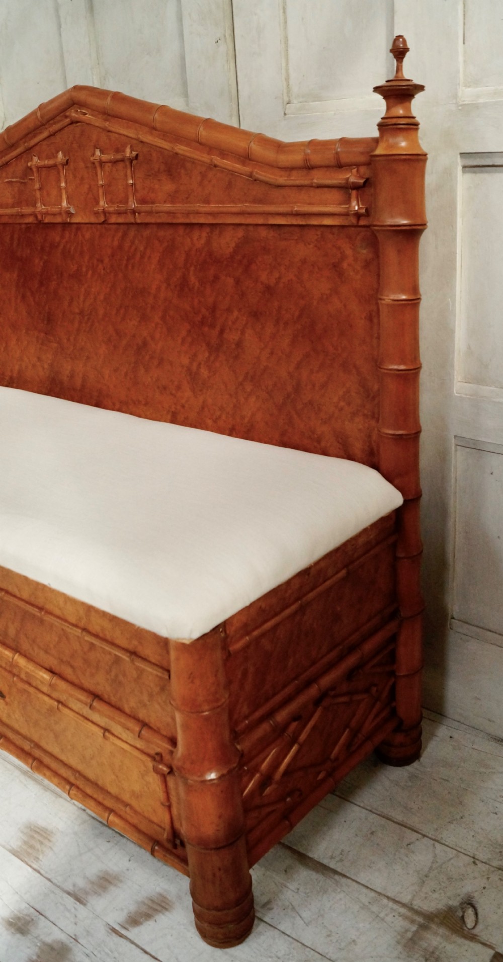 An antique faux bamboo hall bench featuring turned timber frame detailing, a shaped backrest with geometric cresting, and an off-white upholstered seat. View III