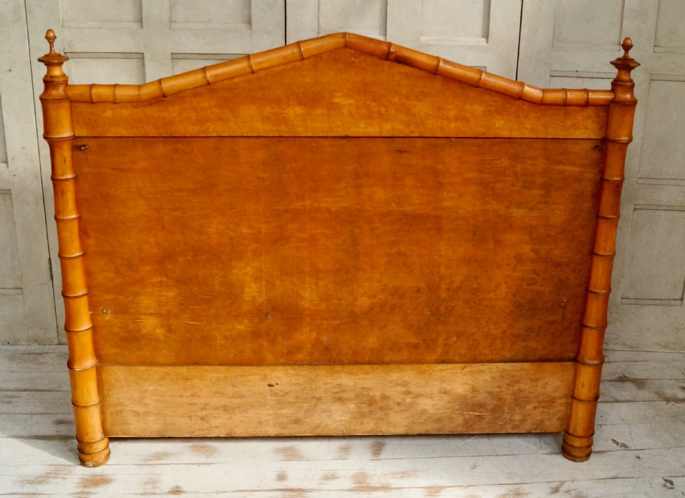 An antique faux bamboo hall bench featuring turned timber frame detailing, a shaped backrest with geometric cresting, and an off-white upholstered seat. View X