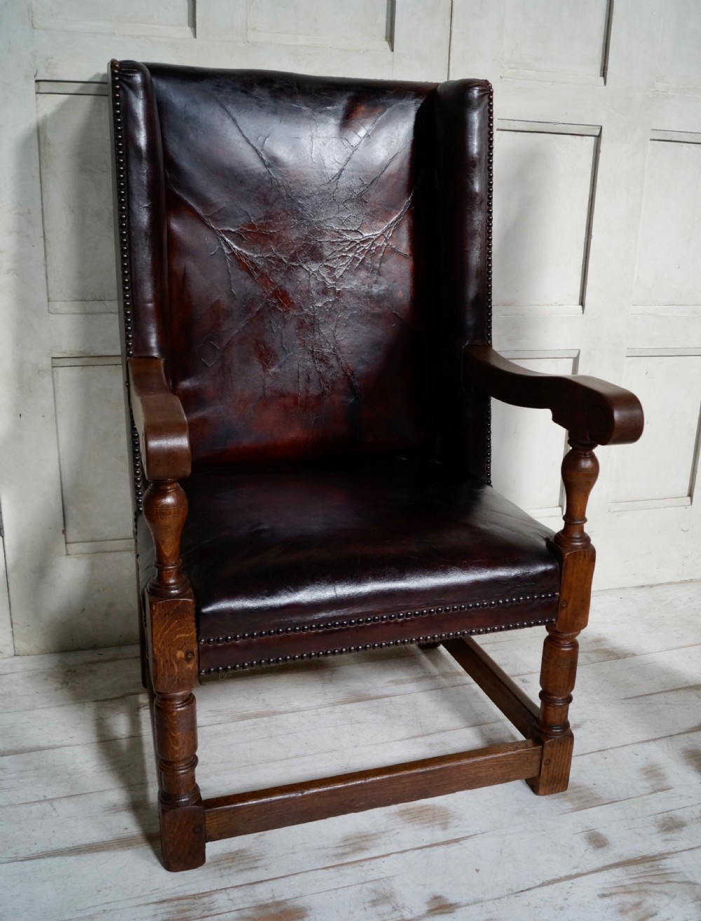 A Victorian library chair featuring dark brown aged leather upholstery with studding detail and a solid oak frame with turned front legs. View II
