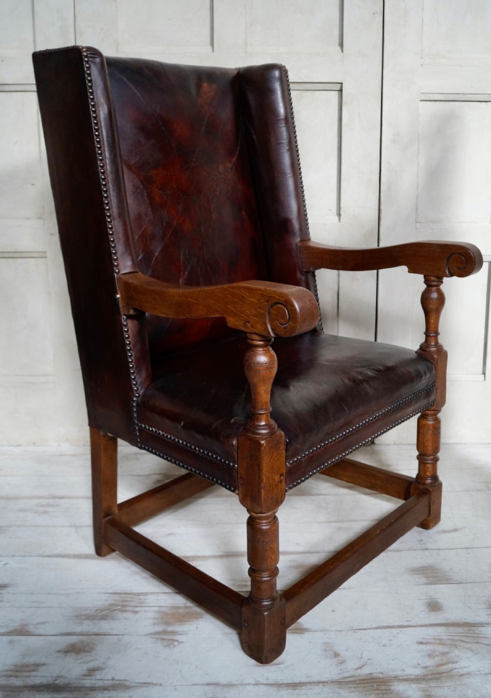 A Victorian library chair featuring dark brown aged leather upholstery with studding detail and a solid oak frame with turned front legs. View III