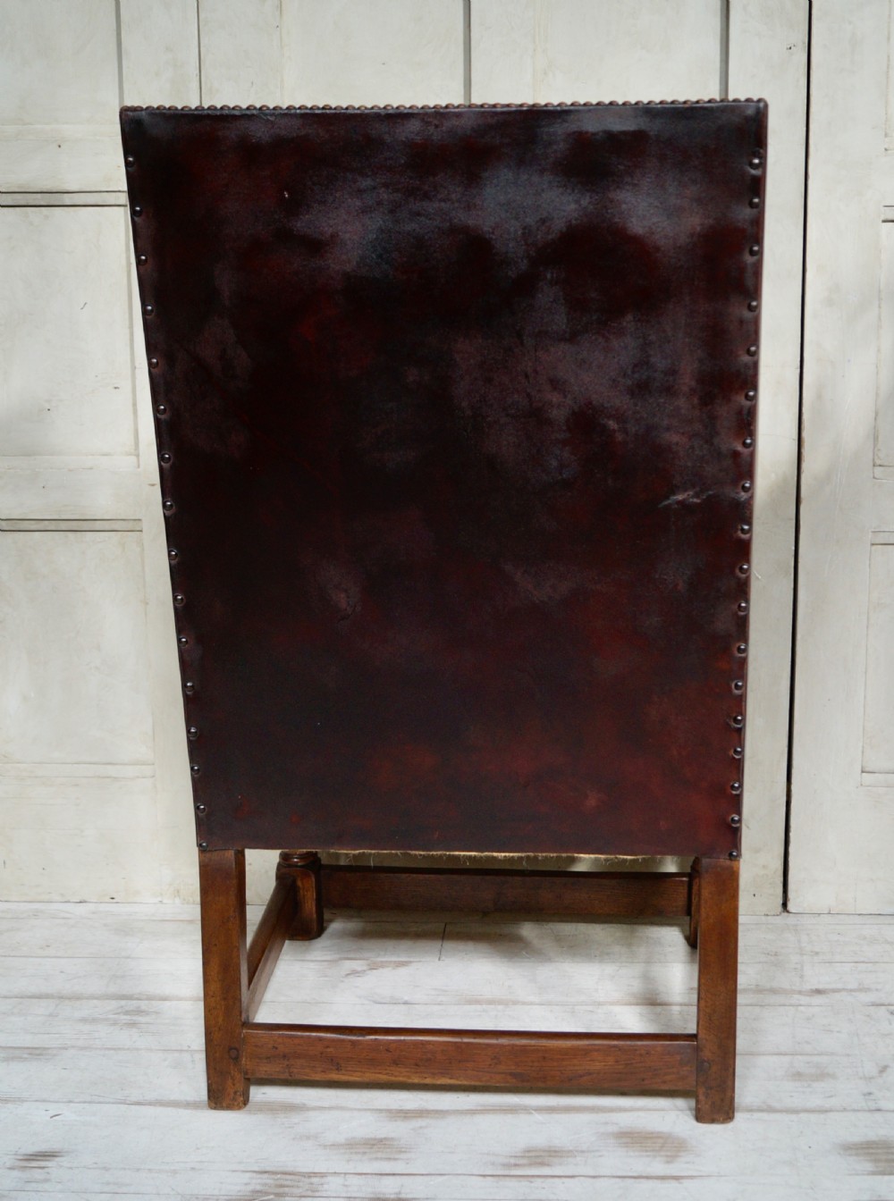 A Victorian library chair featuring dark brown aged leather upholstery with studding detail and a solid oak frame with turned front legs. View VI