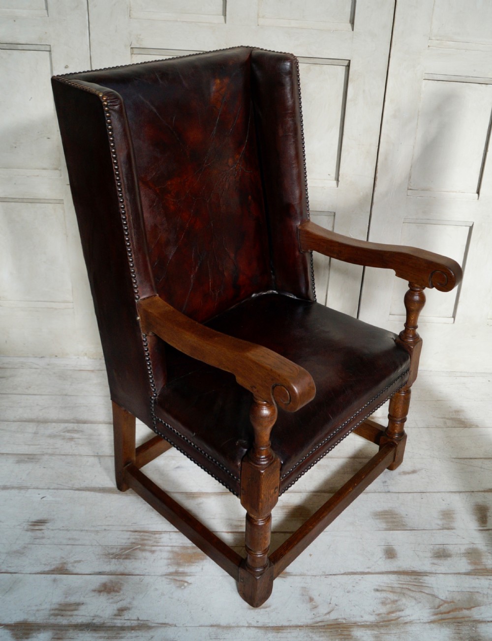 A Victorian library chair featuring dark brown aged leather upholstery with studding detail and a solid oak frame with turned front legs. View VII