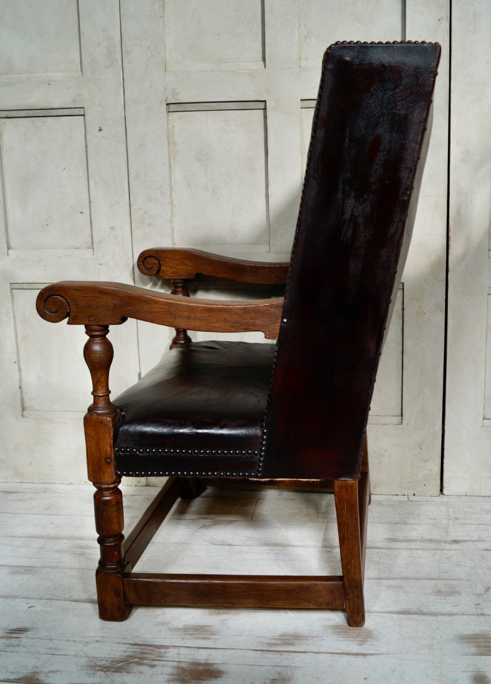 A Victorian library chair featuring dark brown aged leather upholstery with studding detail and a solid oak frame with turned front legs. View VIII